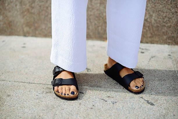 Woman wearing Birkenstock shoes at fashion week